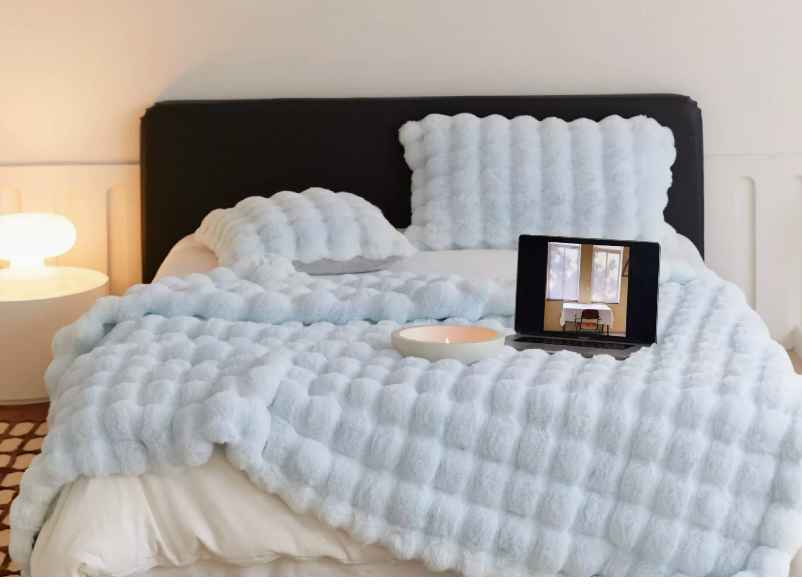 Sky Blue textured blanket on a bed